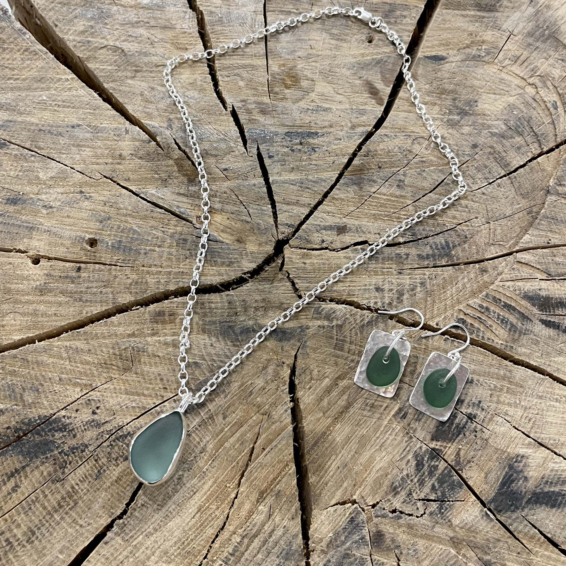 Pendant with Pale Blue sea glass and earrings with dark green seaglass and silver backing.